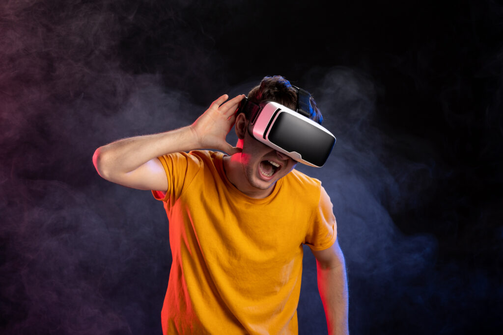 handsome-male-wearing-virtual-reality-headset-dark-surface