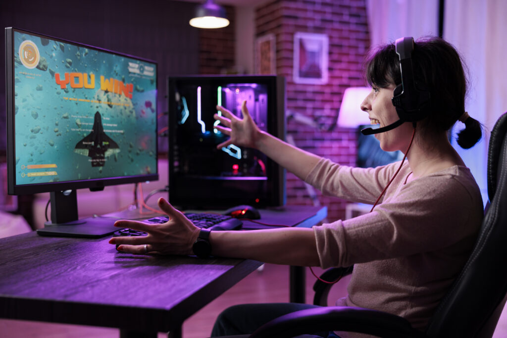 young-gamer-celebrating-video-games-championship-win-online-live-stream-feeling-happy-desk-with-neon-lights-female-streamer-winning-shooter-gaming-tournament-computer